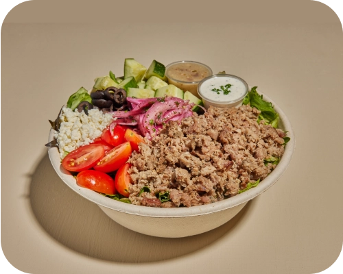Beef and lamb, lettuce, tomatoes, cucumbers, in a Mediterranean salad bowl.