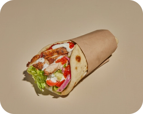Chicken, vegetables, and sauces wrapped in a warm, fresh pita.