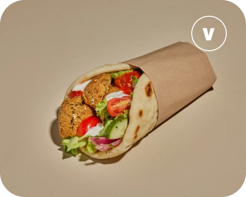 Falafel, cucumbers, tomatoes, lettuce, onions, and sauces wrapped in a pita.